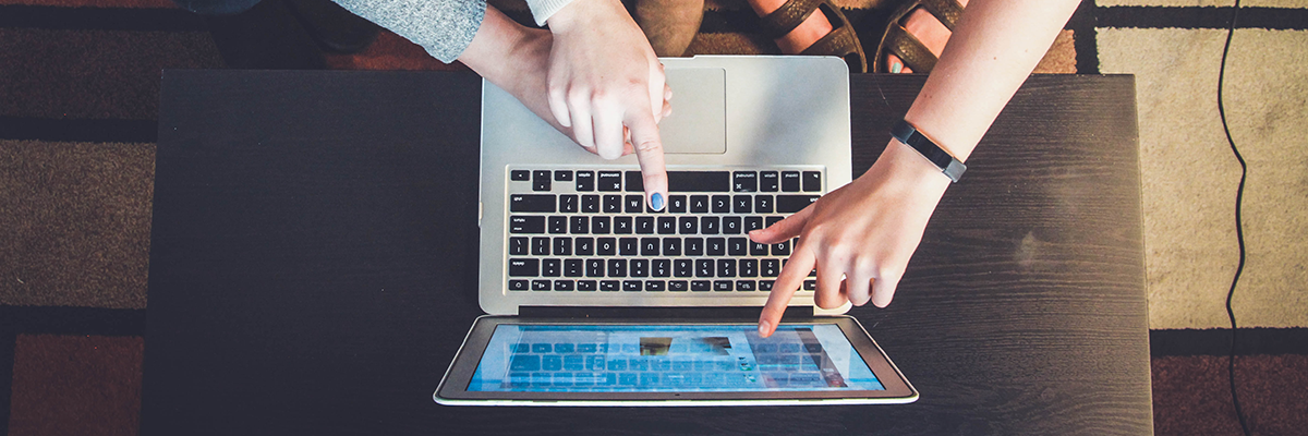 People pointing to a laptop screen