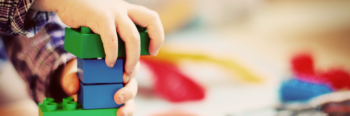 Child playing with colorful building blocks