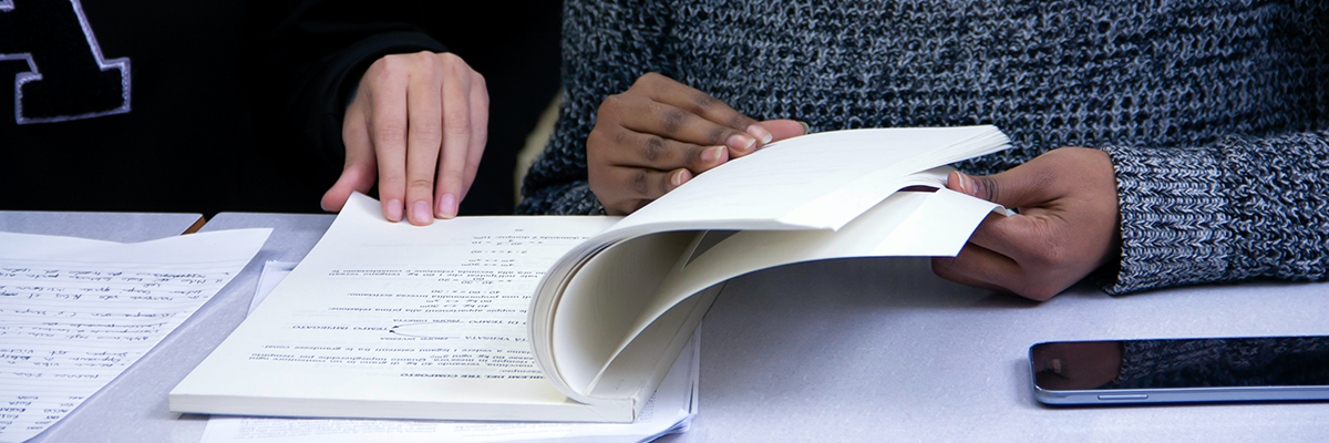 Two people looking through test booklet